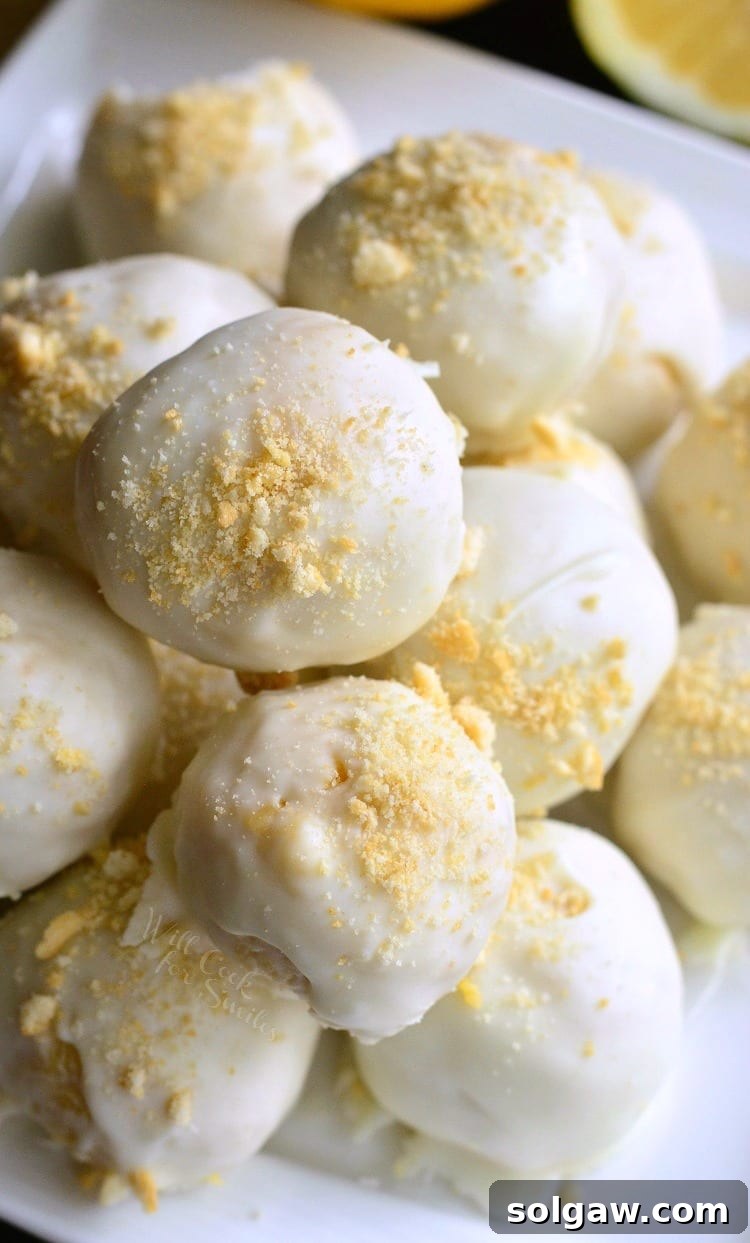 Zesty Coconut Oreo Delights 6 Lemon Oreo Coconut Cookie Truffles stacked up on a white plates