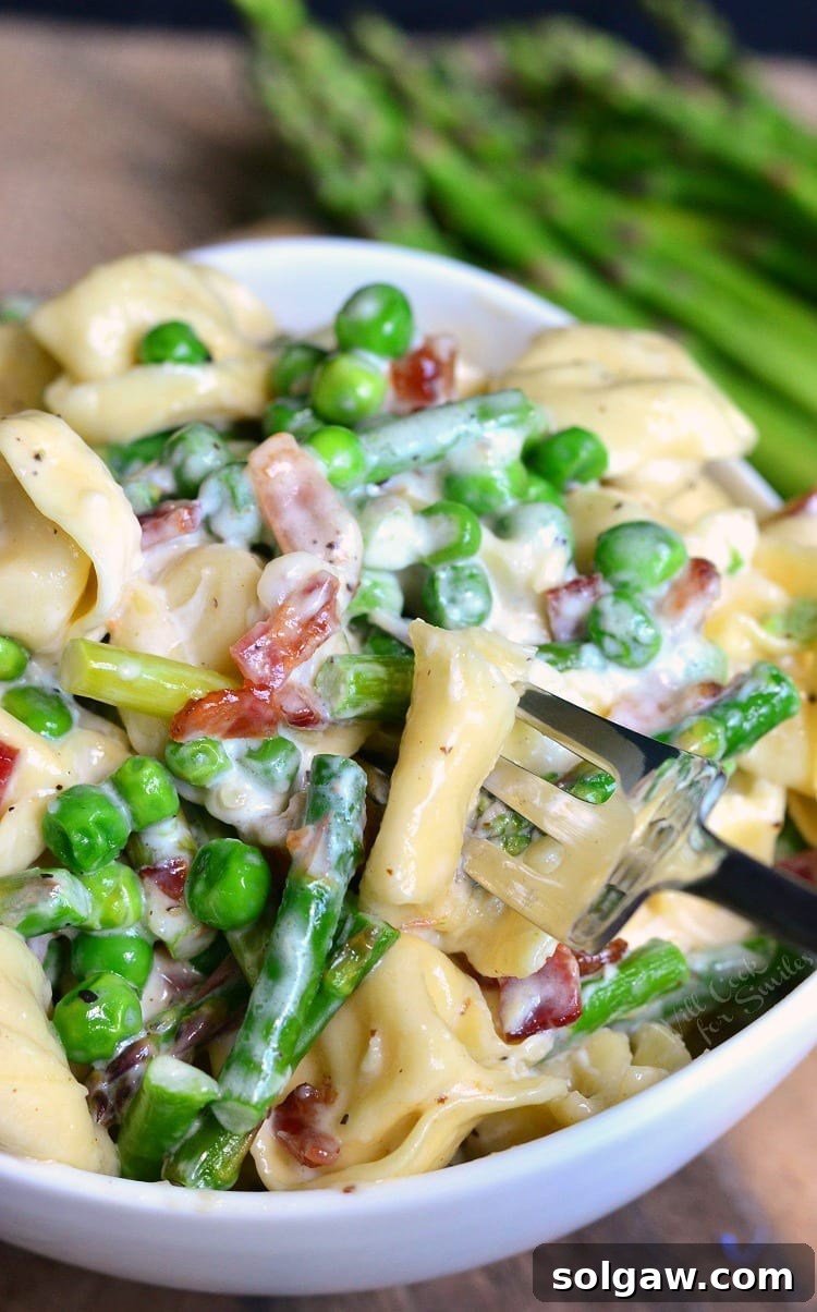scooping out some tortellini with a fork.