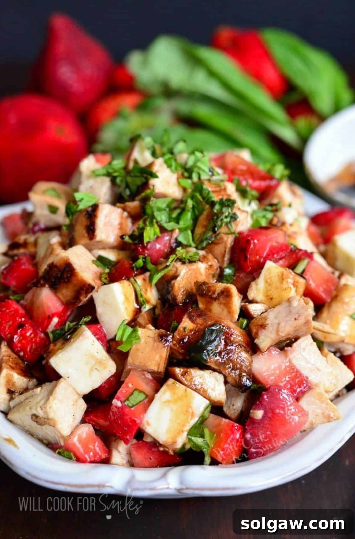 Fresh parsley garnishes a balsamic strawberry chicken salad.