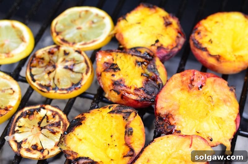 lemons and peaches on a charcoal grill 