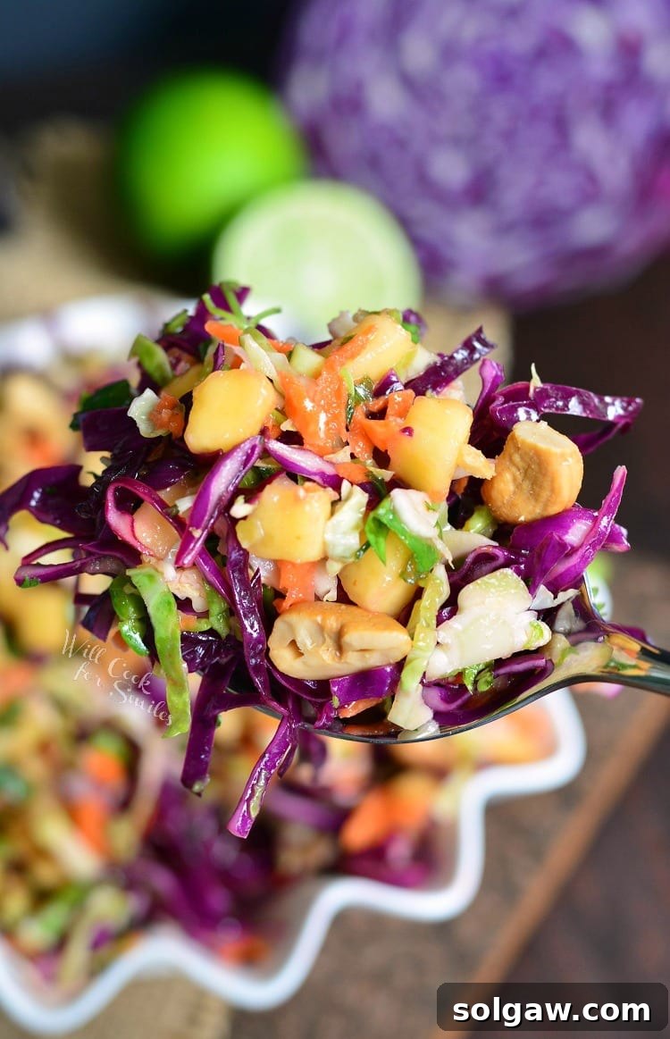 Scoop of refreshing Tropical Coleslaw with mango, lime, and cashews.