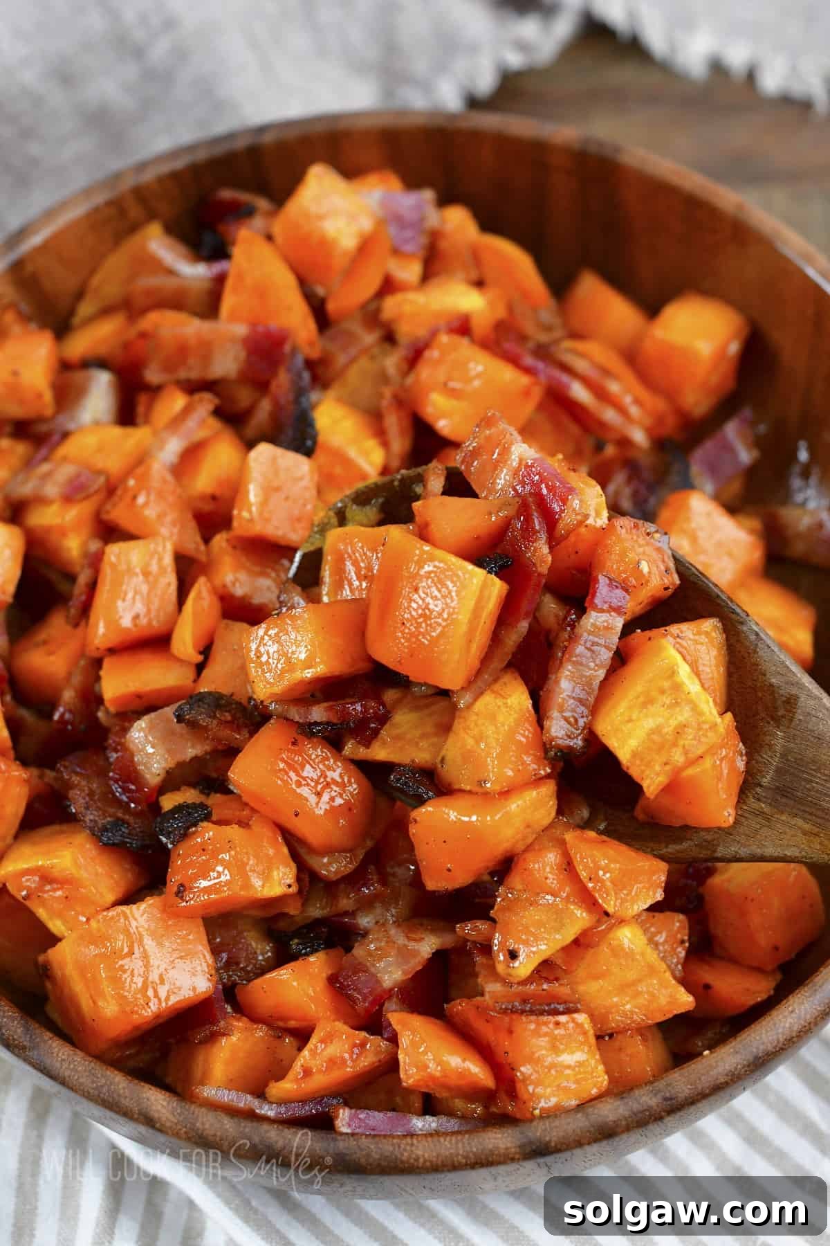 scooping out some roasted potatoes and bacon.