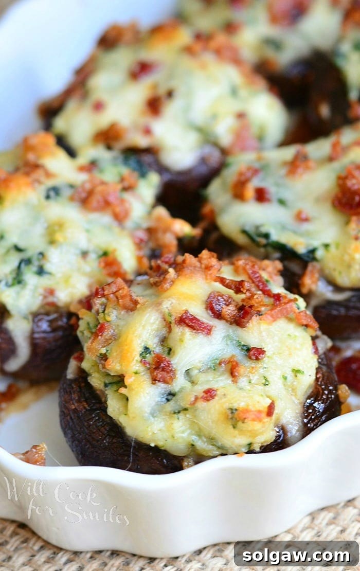 Bacon Spinach and Four Cheese Stuffed Mushrooms in a baking dish