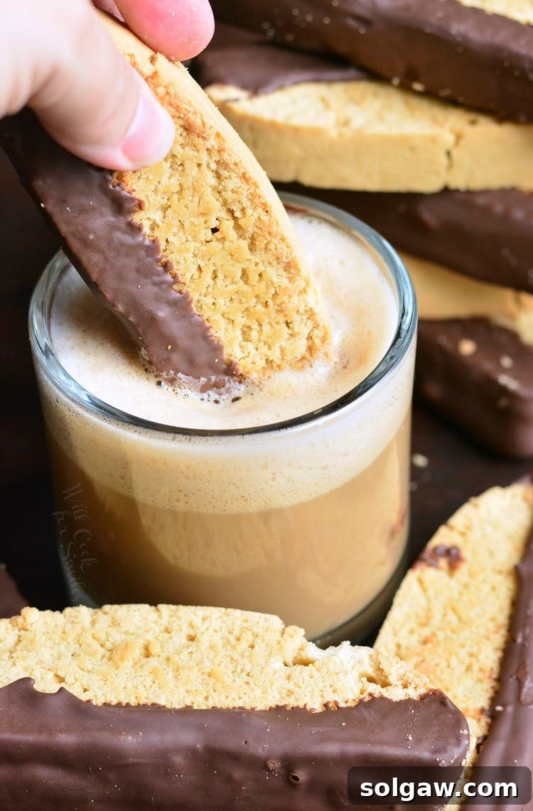 dipping Dark Chocolate Cappuccino Biscotti in espresso