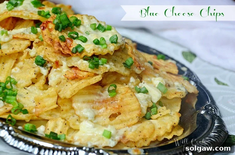 Shot from above silver platter with blue cheese chips on a white and green cloth, slight angle to the left, highlighting the delicious finished appetizer.