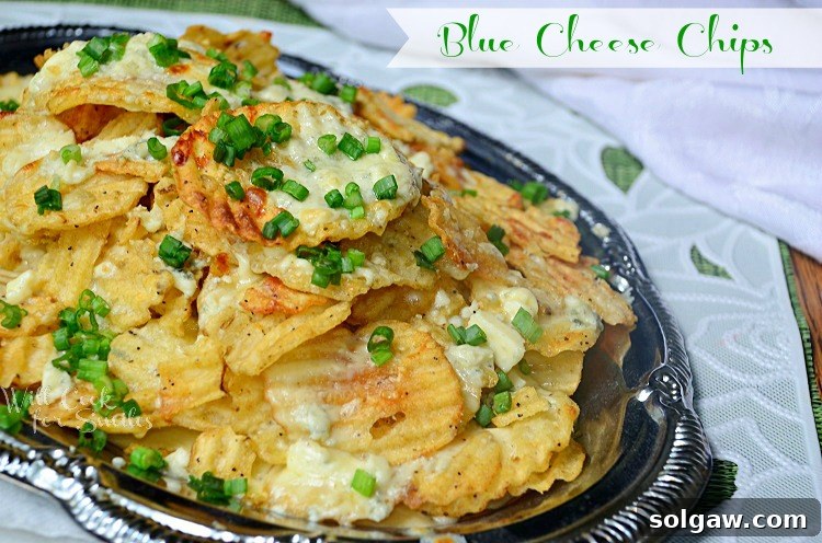 Shot from above silver platter with blue cheese chips on a white and green cloth, slight angle to the left, showcasing the delicious finished appetizer ready to be served.