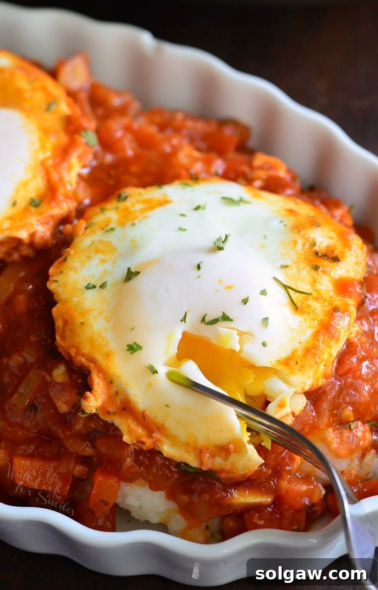 Shakshuka with Parmesan Polenta in a bowl with a fork 