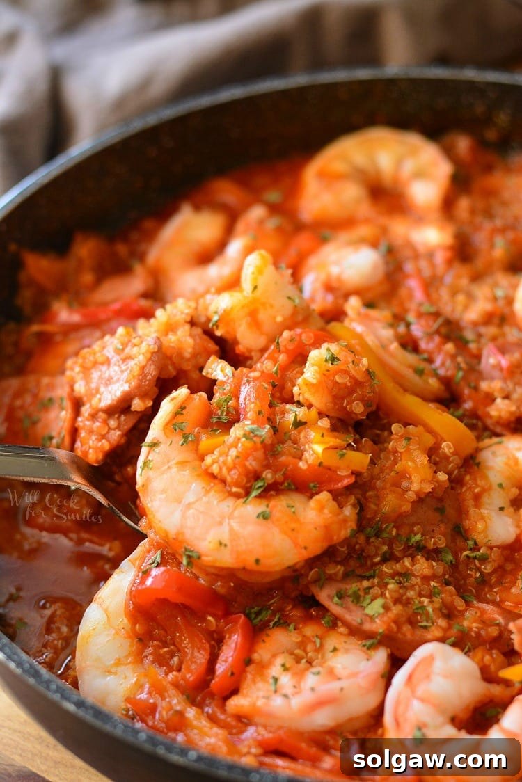 Smoked Sausage and Shrimp Jambalaya with Quinoa in a pan with a spoon