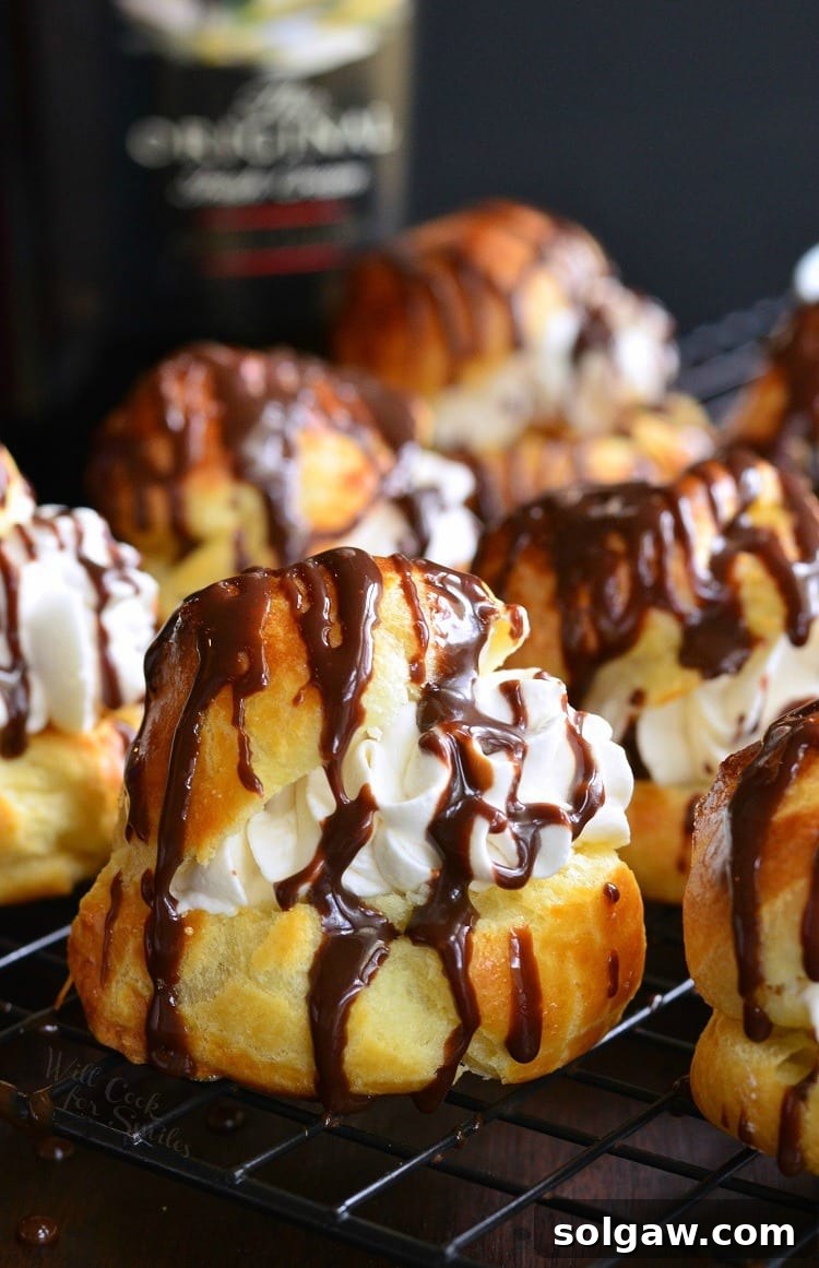 Baileys Cream Puffs arranged beautifully on a cooling rack.