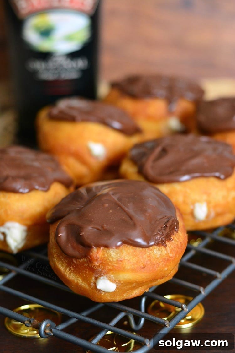 Bailey's Cheesecake Doughnuts cooling on a wire rack, ready to be enjoyed.