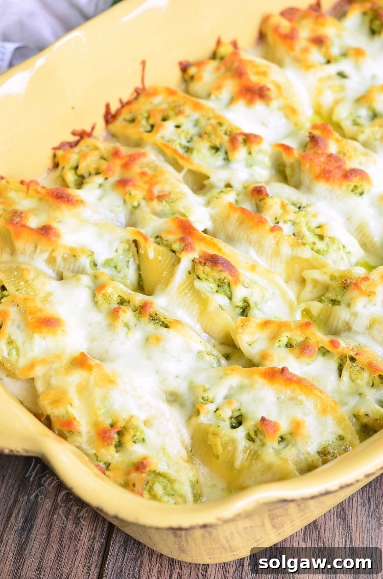 Cheesy Pesto Chicken Stuffed Shells. Pasta shells stuffed with a mixture of ricotta cheese and pesto chicken, baked in a simple white sauce, and topped with extra Mozzarella cheese.