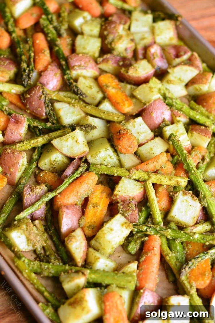 Pesto Roasted Potatoes Carrots and Asparagus on a baking sheet 