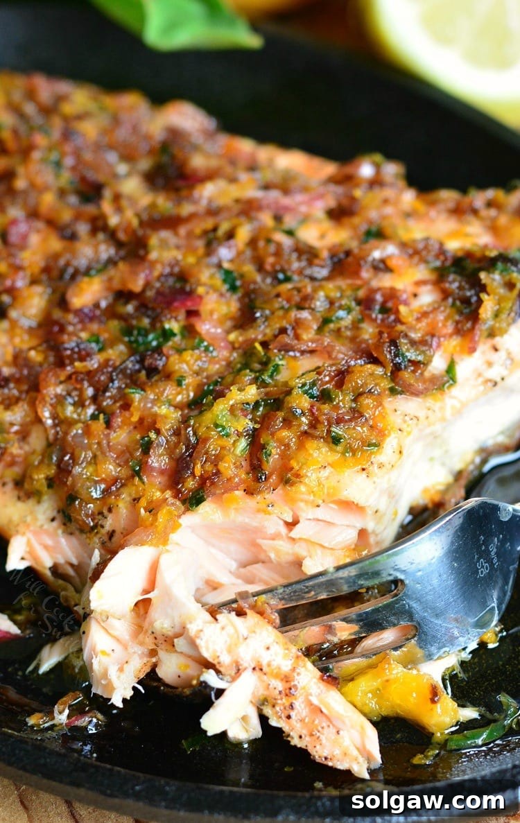 Grilled Salmon with Brown Butter Citrus Sauce on a plate with a fork