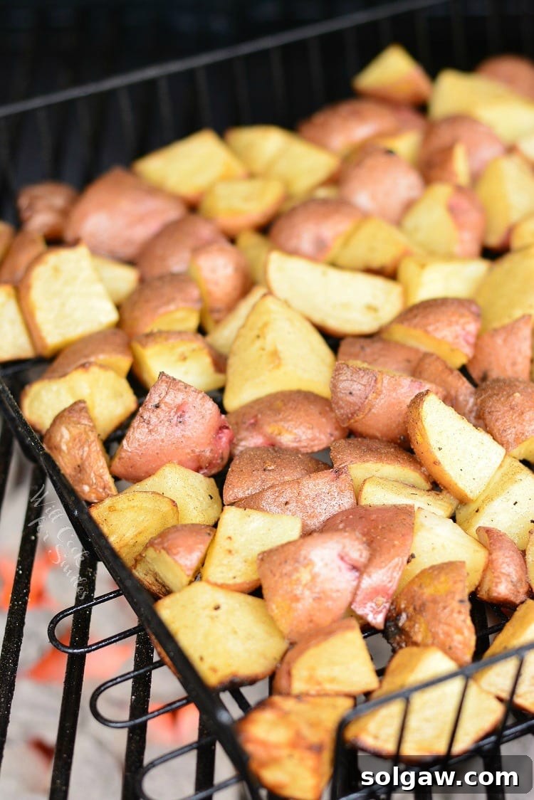 Roasted Garlic Potatoes in a grilling basket on the grill