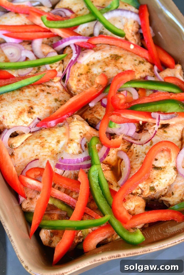 Southwest Chicken Marinade and Baked Chicken with green and red bell peppers and red onion in a casserole dish 