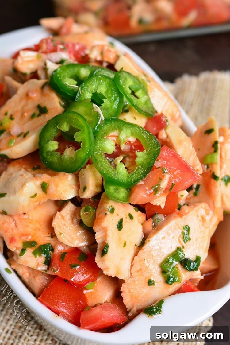 Spicy Mexican Chicken Salad in a rustic bowl, garnished with fresh cilantro and lime wedges