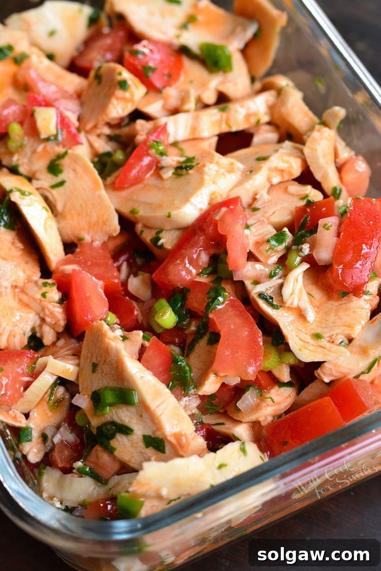Close-up of Spicy Mexican Chicken Salad in a glass baking dish, showcasing its vibrant colors and fresh ingredients