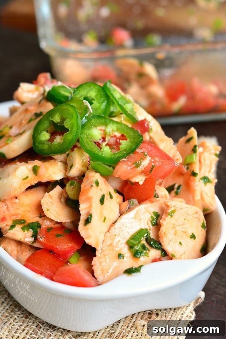 A large serving bowl filled with a generous portion of Spicy Mexican Chicken Salad, ready for serving