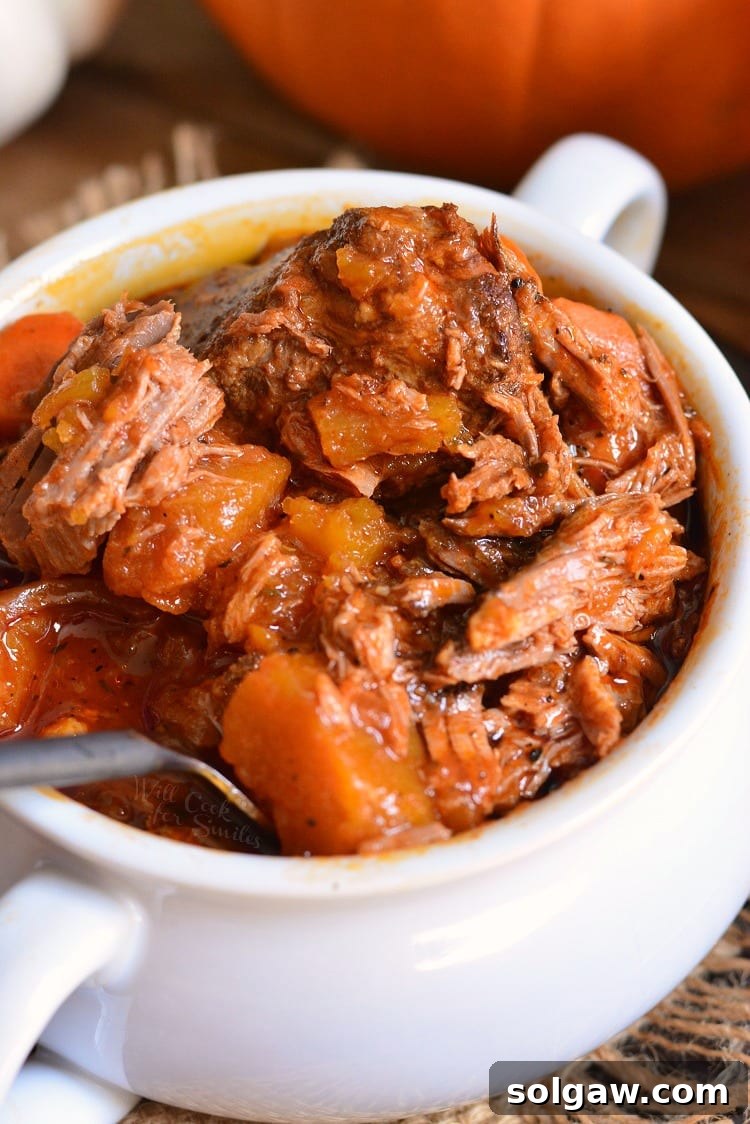 Crock Pot Roast with pumpkin in a bowl with a fork