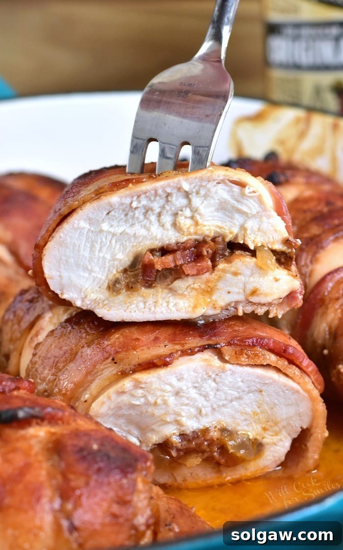 Mouthwatering Bacon Wrapped BBQ Stuffed Chicken Breast, sliced to reveal savory onion-bacon filling