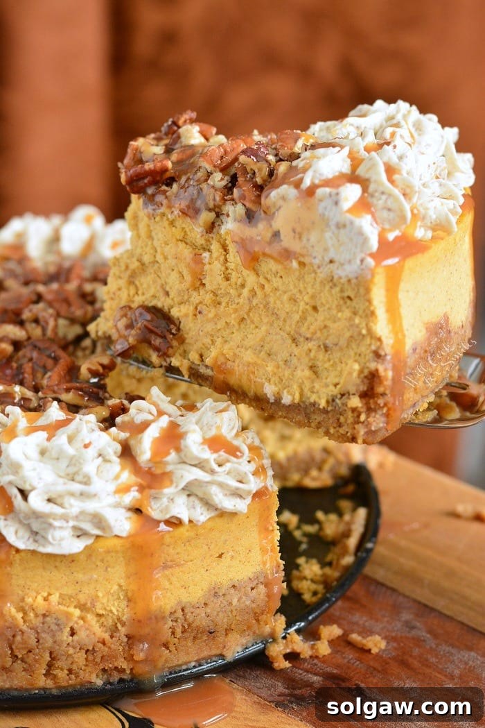 Whole Caramel Pecan Pumpkin Cheesecake on a rustic cutting board, ready to be served