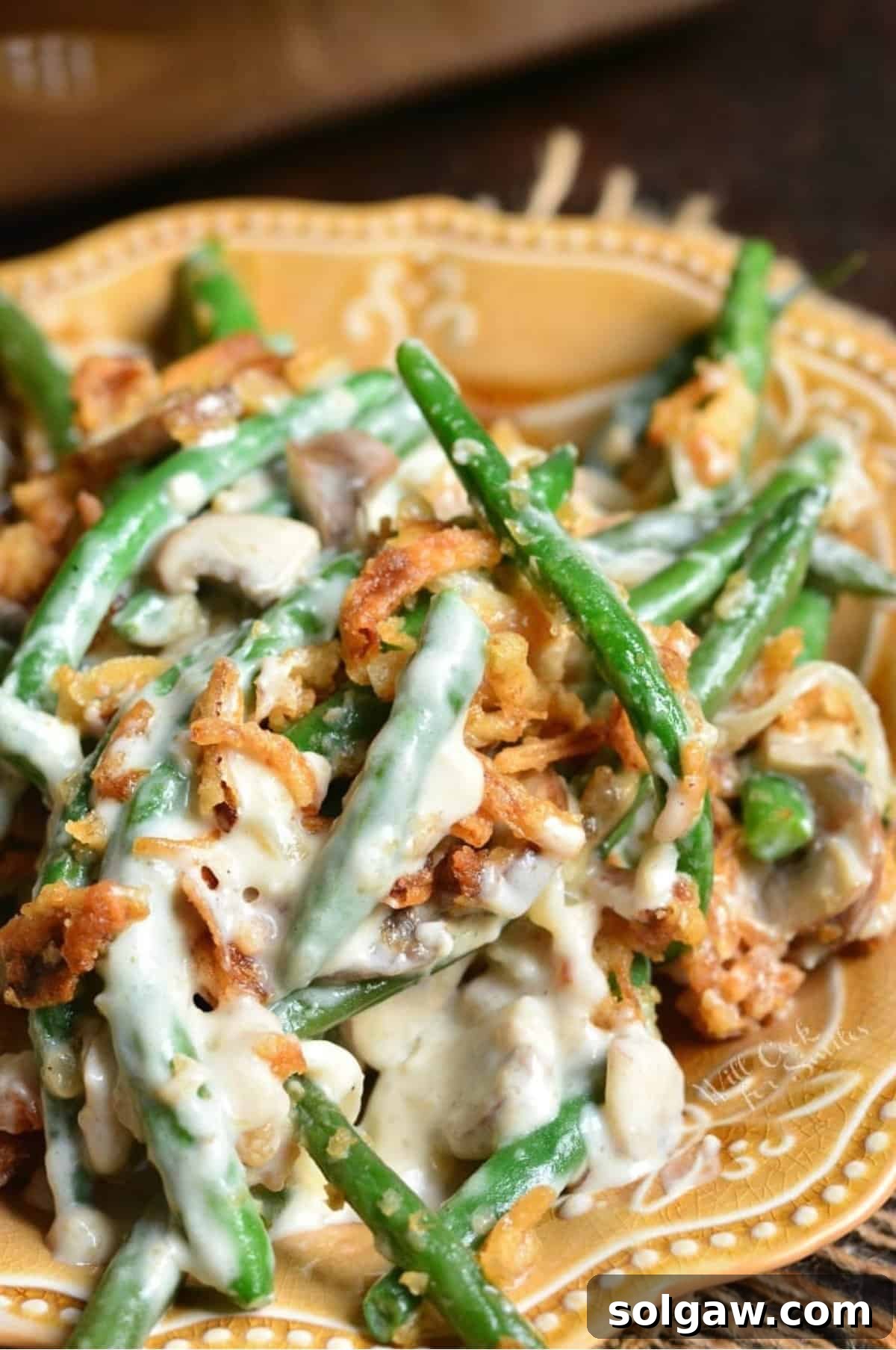 A single serving of the delicious homemade green bean casserole on a white plate.