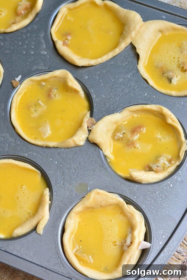 Unbaked Leftover Turkey Breakfast Egg Muffins filling in a muffin tin