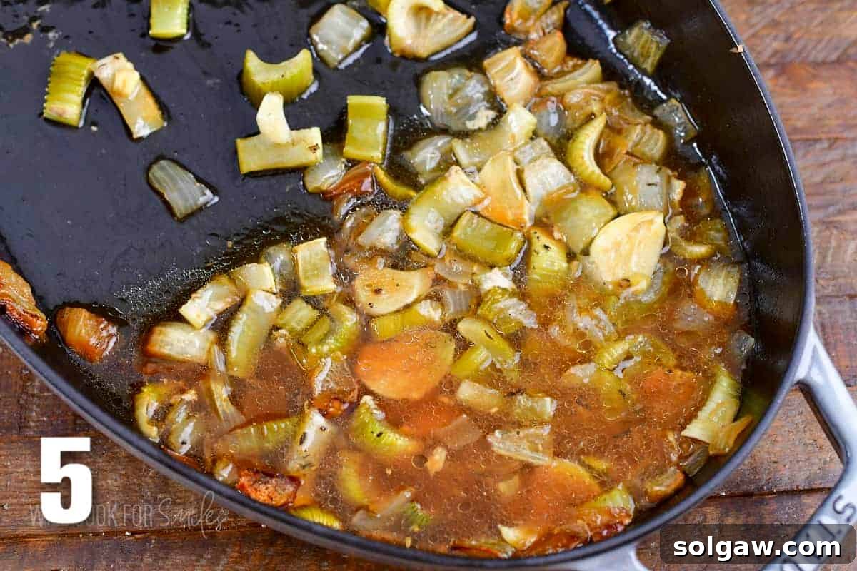 Aromatic Garlic Pork Loin 8 leftover pan drippings and veggies in the roasting pan.