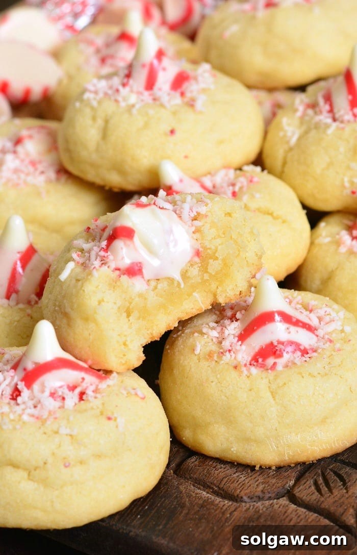 Close-up of baked Thumbprint Cookies with melted Candy Cane Kisses, showcasing their festive appeal.