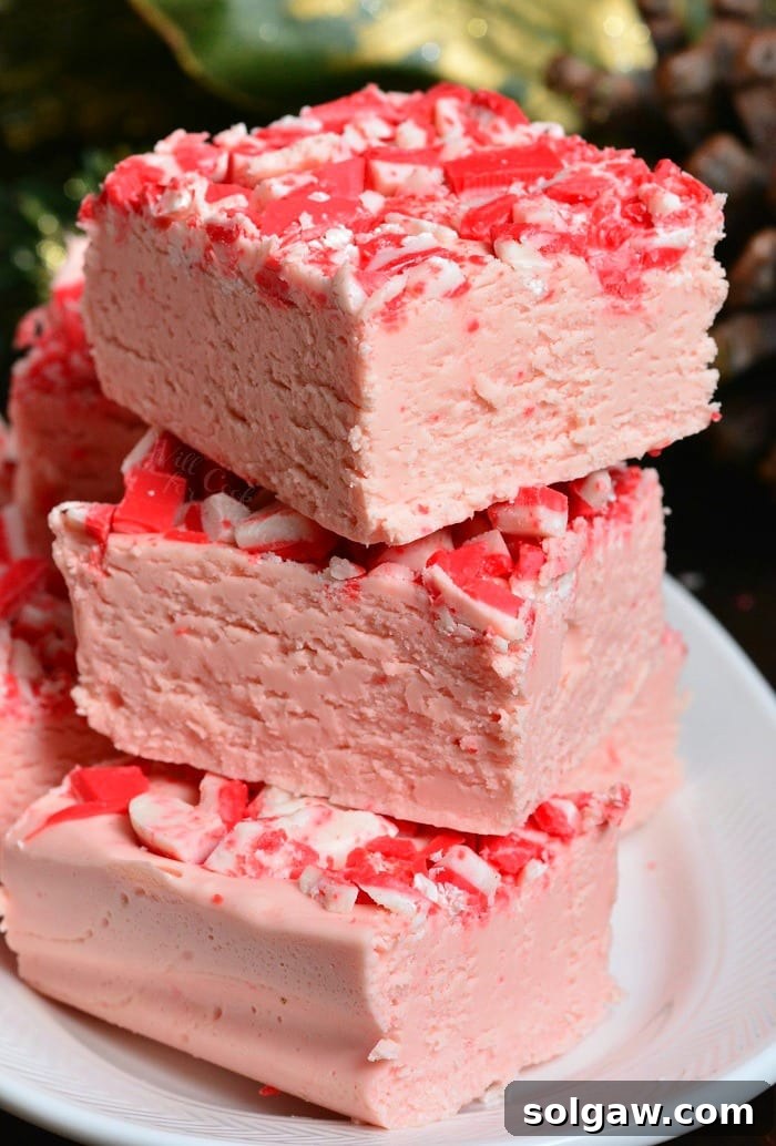 Delicious Peppermint White Chocolate Fudge pieces stacked on a plate