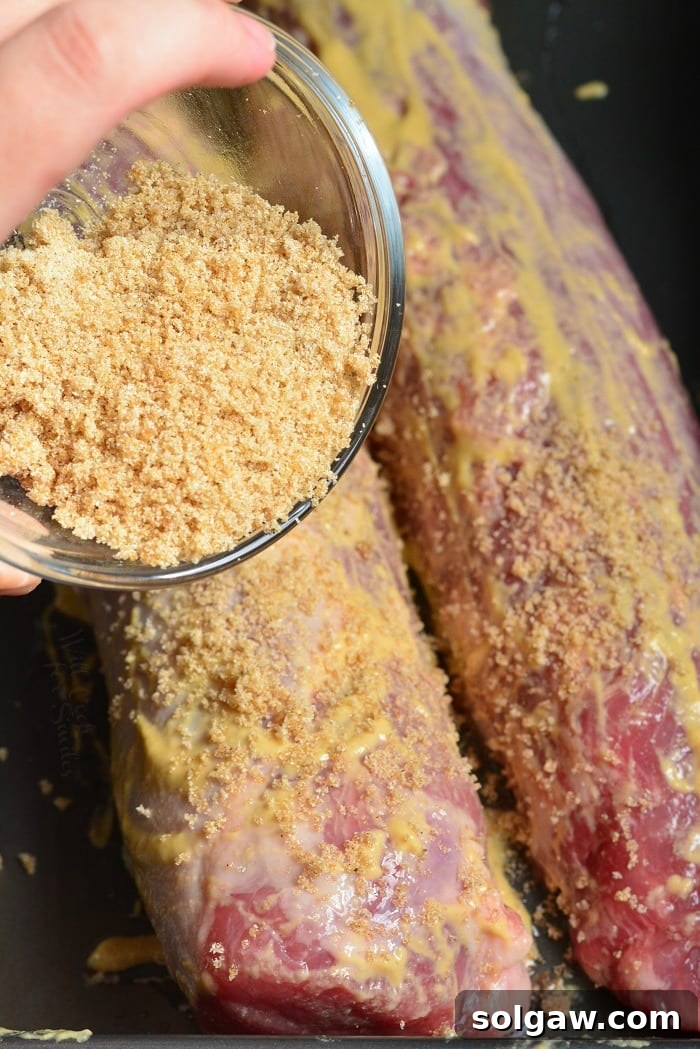 sprinkling brown sugar over Dijon mustard rubbed pork tenderloins.