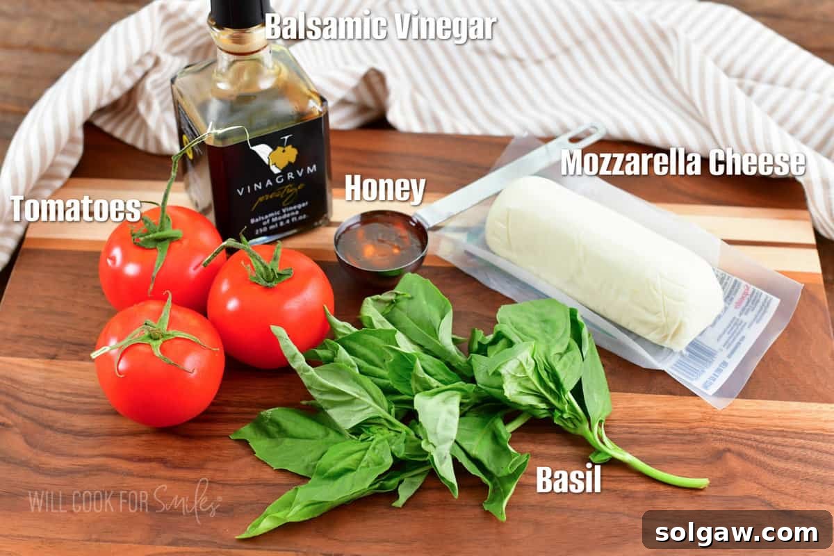 labeled ingredients to make caprese salad on the cutting board.