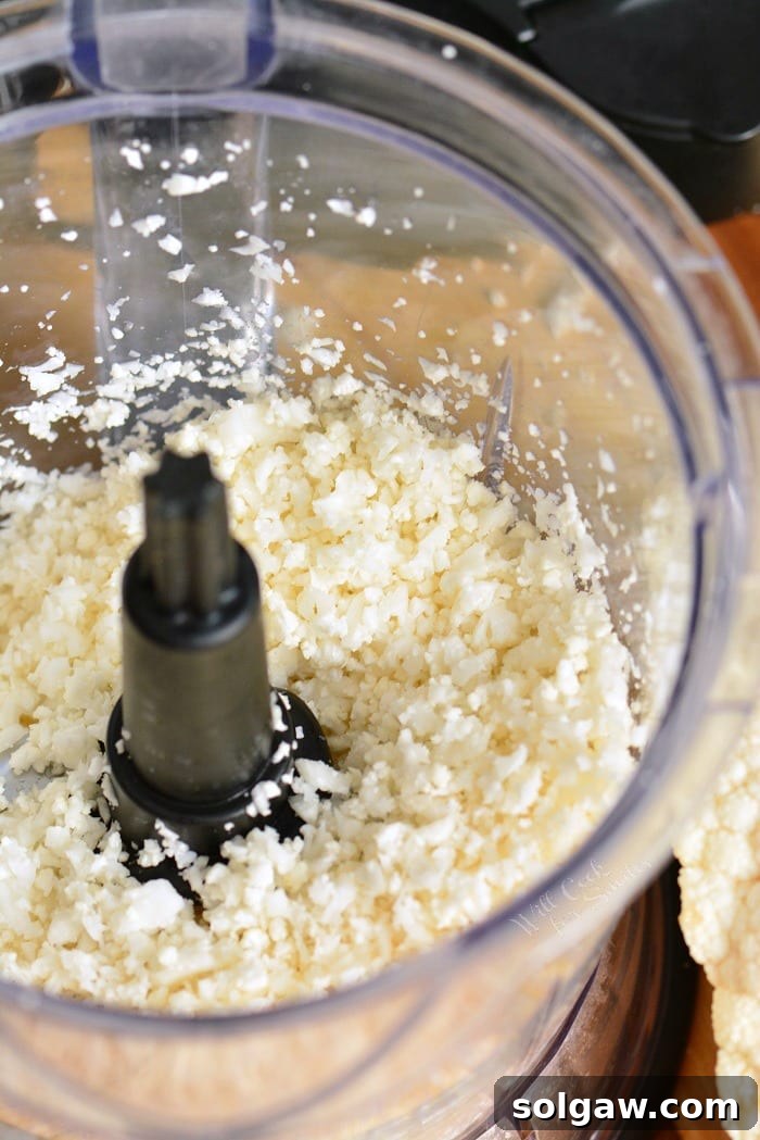 Cauliflower rice being shredded with a food processor 