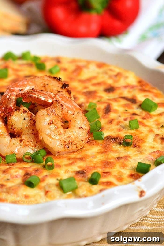 Cajun Shrimp Dip in a baking dish with shrimp on top