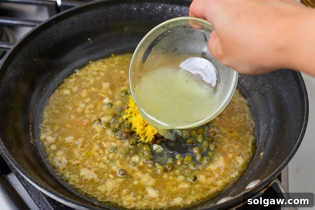 Adding fresh lemon juice, capers, and lemon zest to the simmering sauce, completing its iconic flavor.