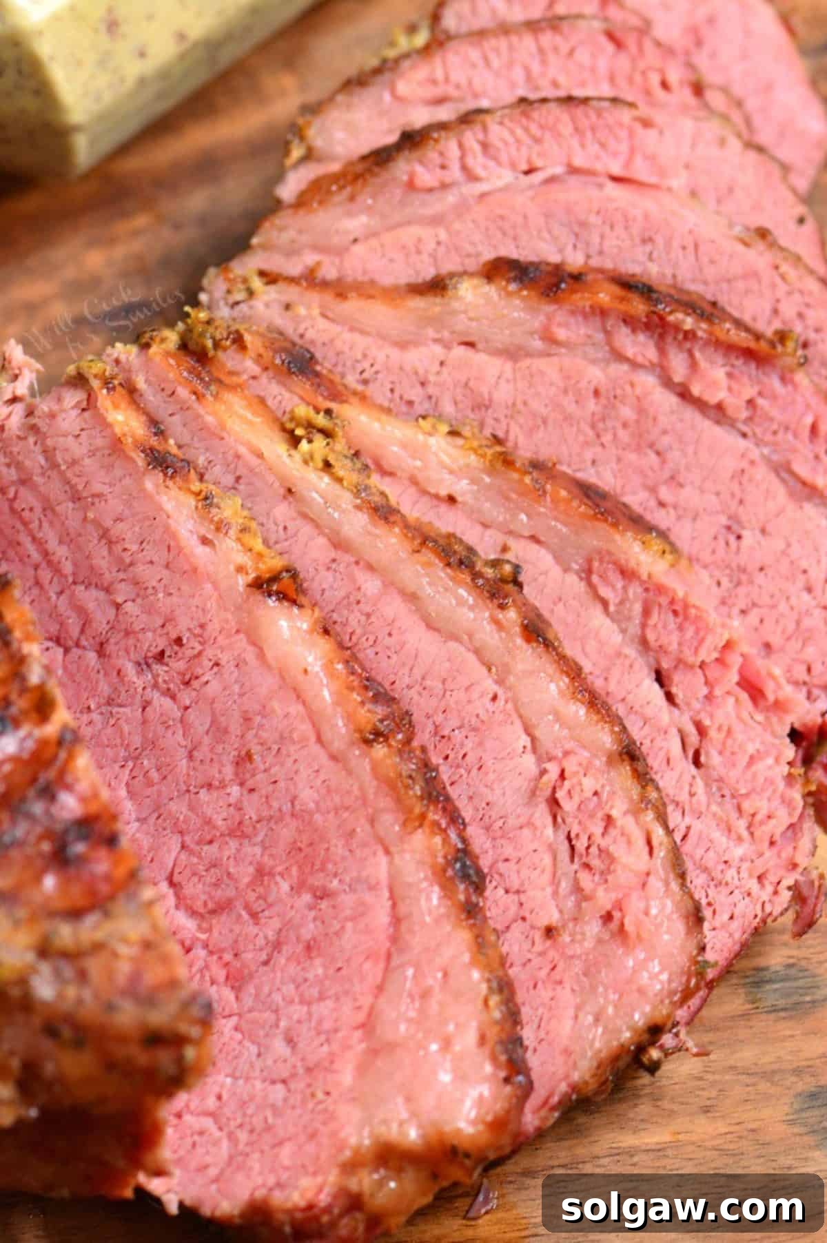 Perfectly cooked Instant Pot corned beef brisket on a rustic wooden cutting board, ready to be sliced and served.