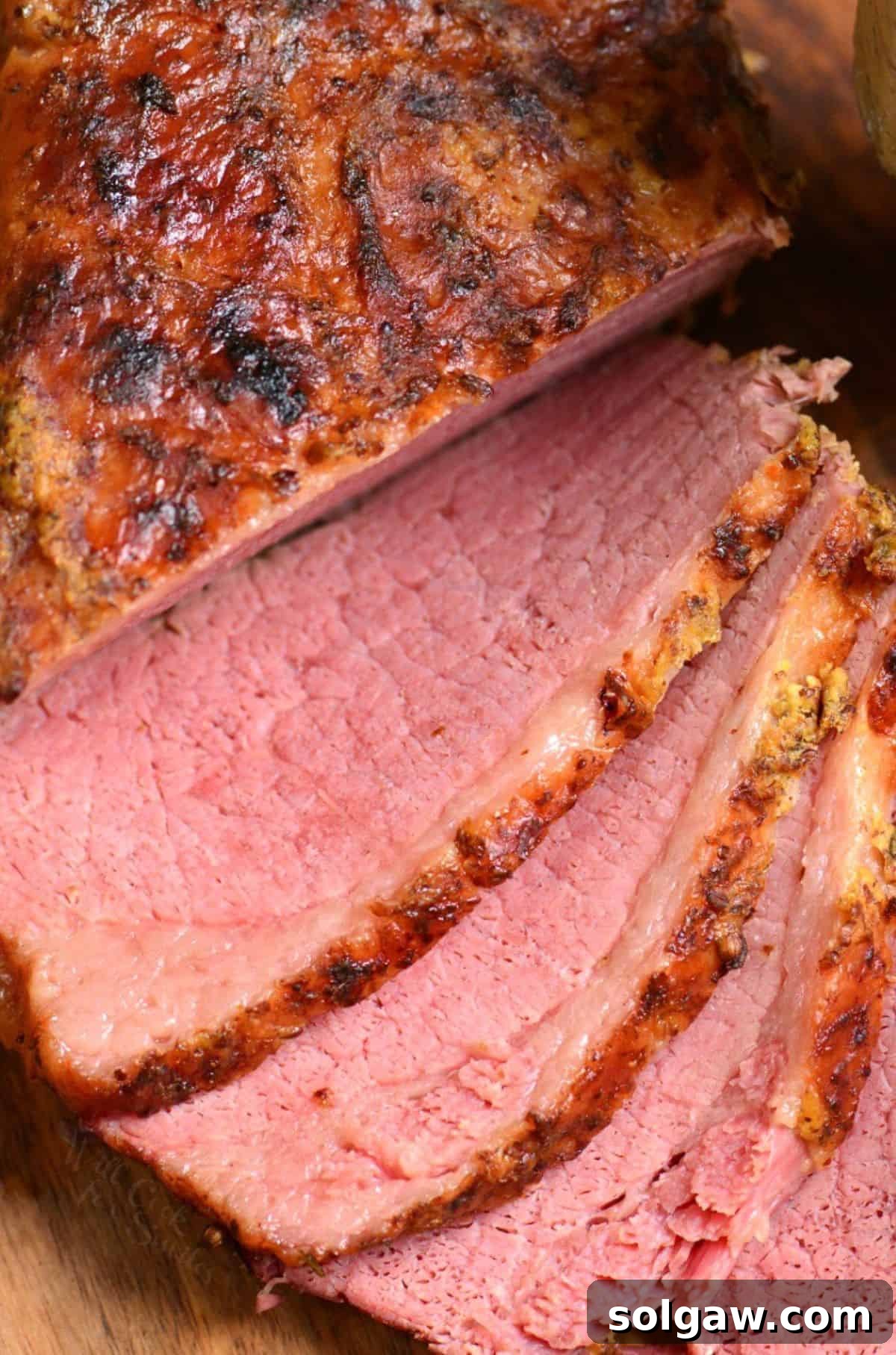 Beautifully sliced corned beef on a wooden cutting board, ready for a delicious meal or sandwich.