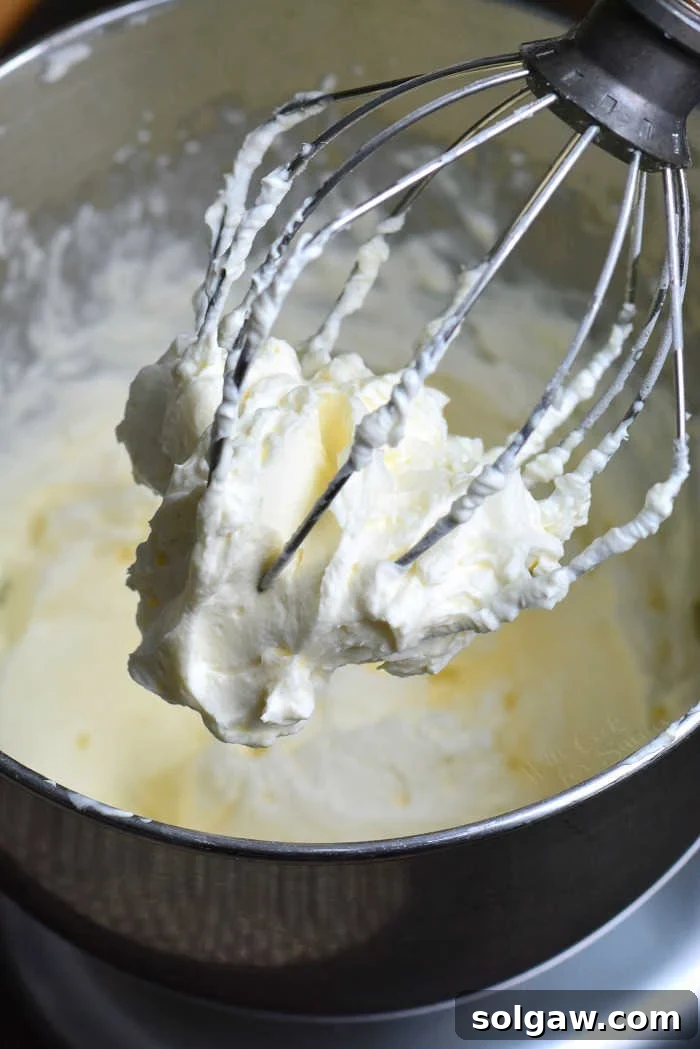 Beating cream cheese in a stand mixer