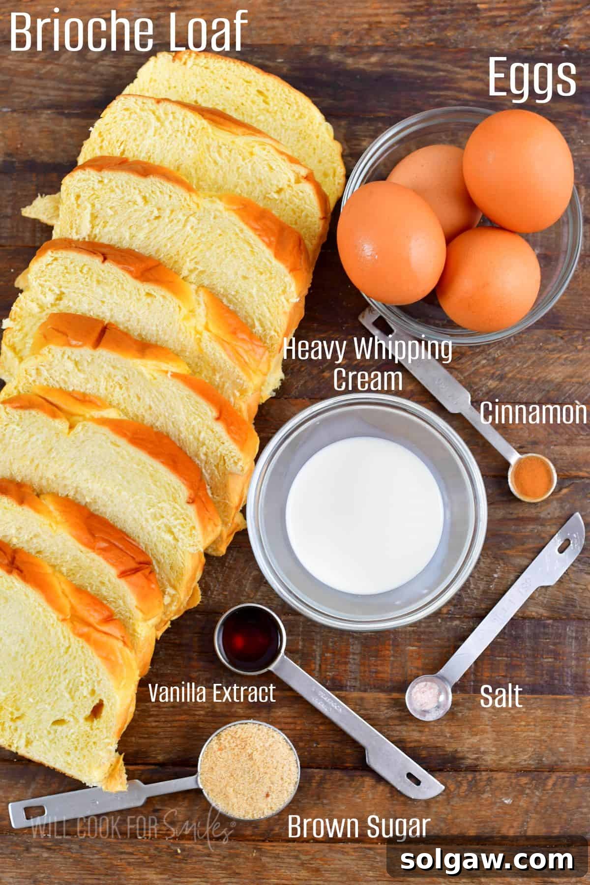 Essential ingredients for classic French Toast, including eggs, heavy cream, and vanilla, neatly arranged on a rustic wooden board.