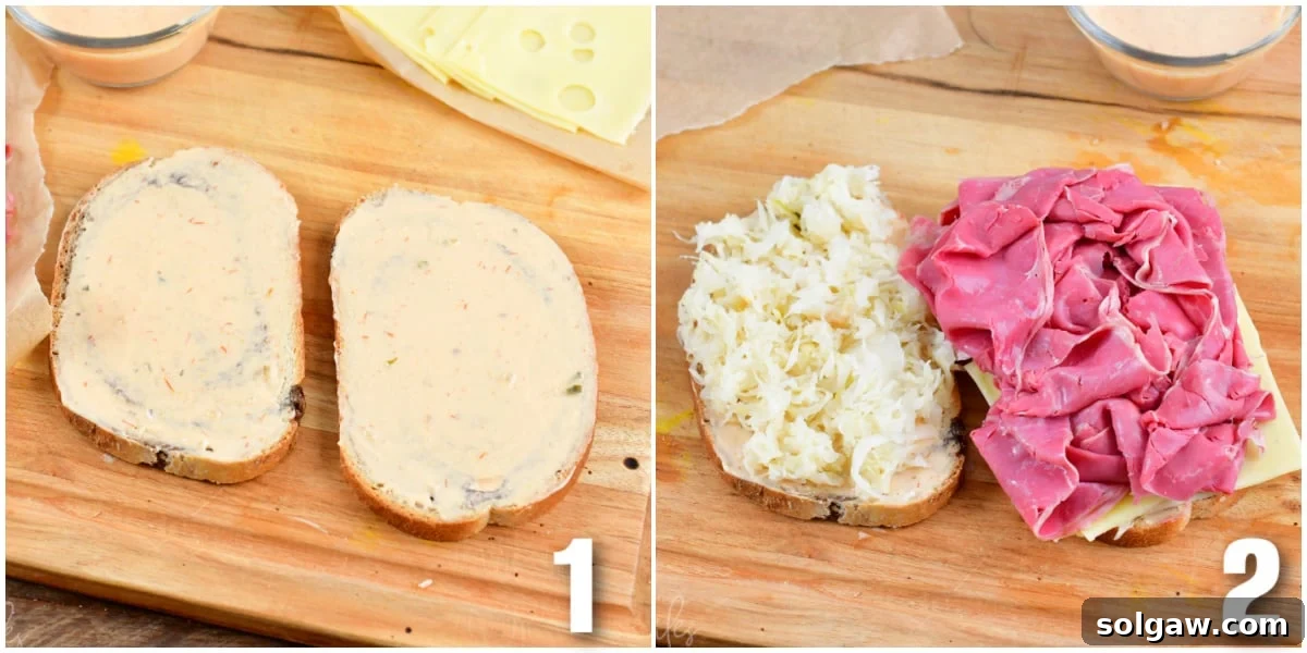Rye bread slices are being coated with Thousand Island dressing, then topped with sauerkraut and sliced corned beef.