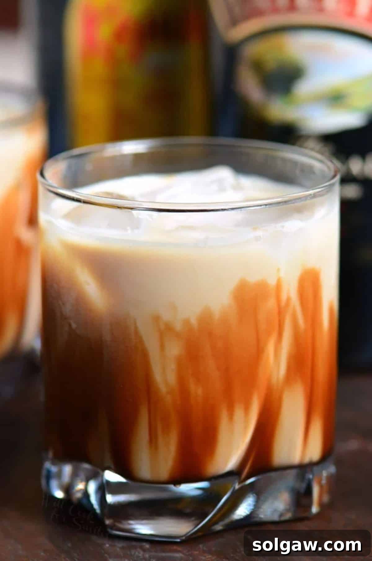 Fork in the Torrent 8 Creamy Mudslide cocktail in a short glass with chocolate syrup elegantly drizzled inside.