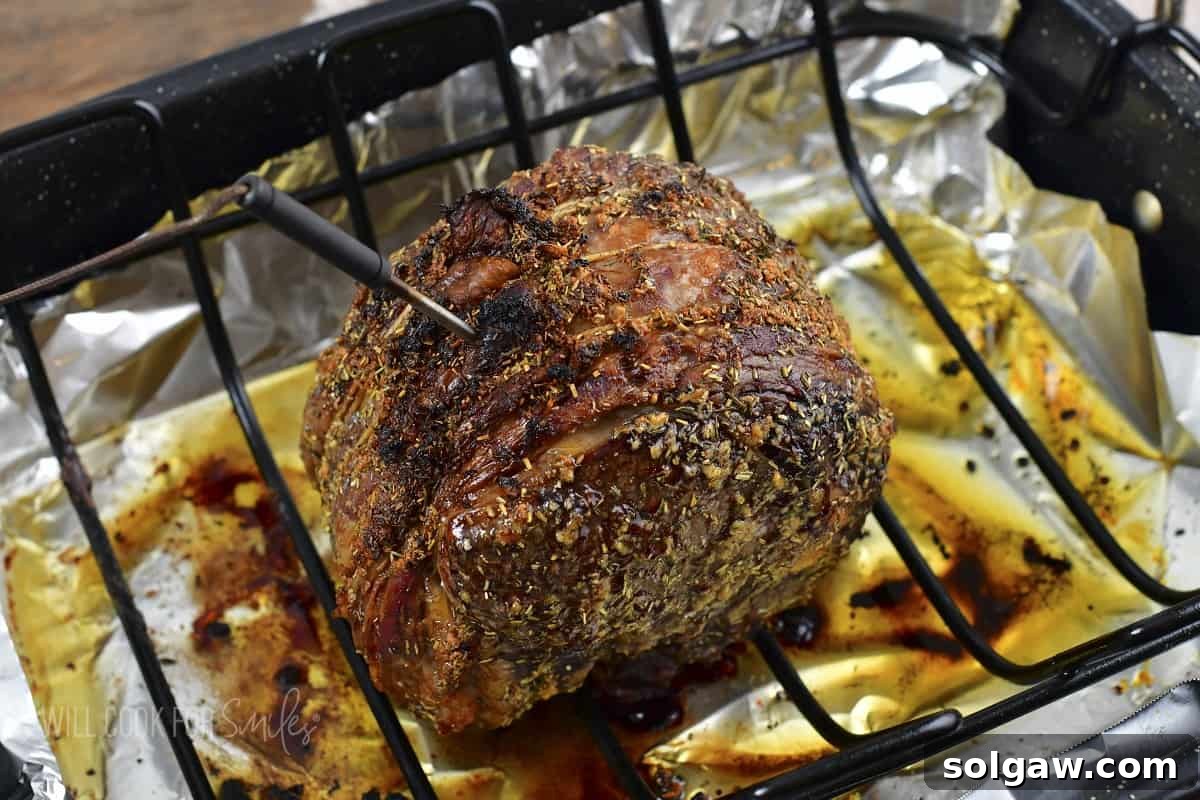 cooked prime rib roast in the roasting pan after removing from oven.