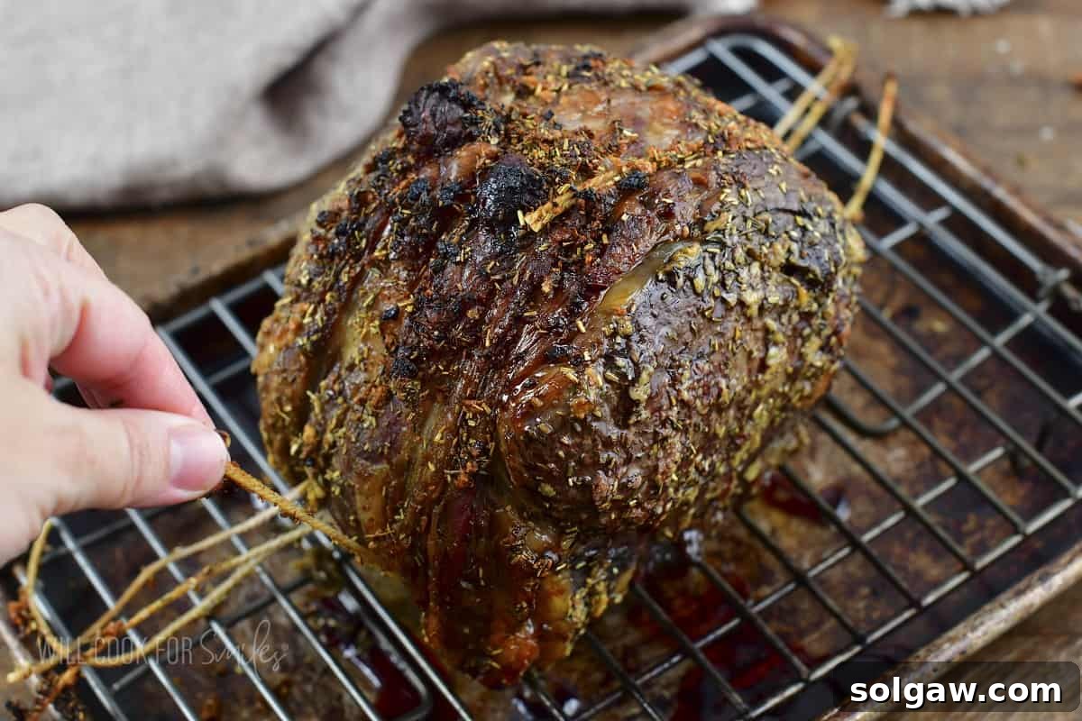 taking off the cooking twine off the prime rib roast before resting.