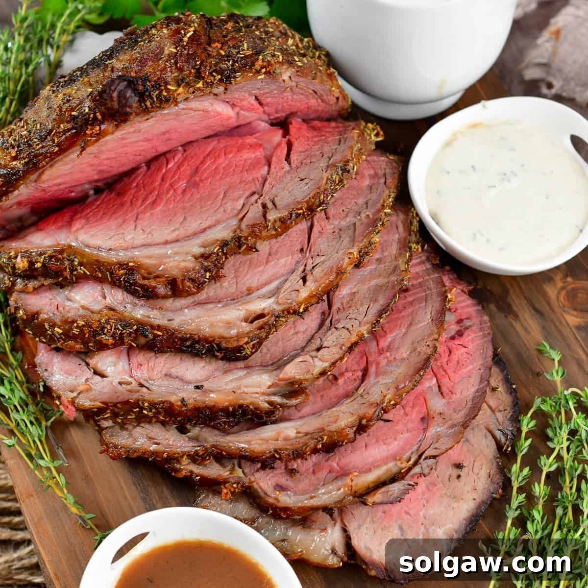 closeup of sliced prime rib with sauces around.