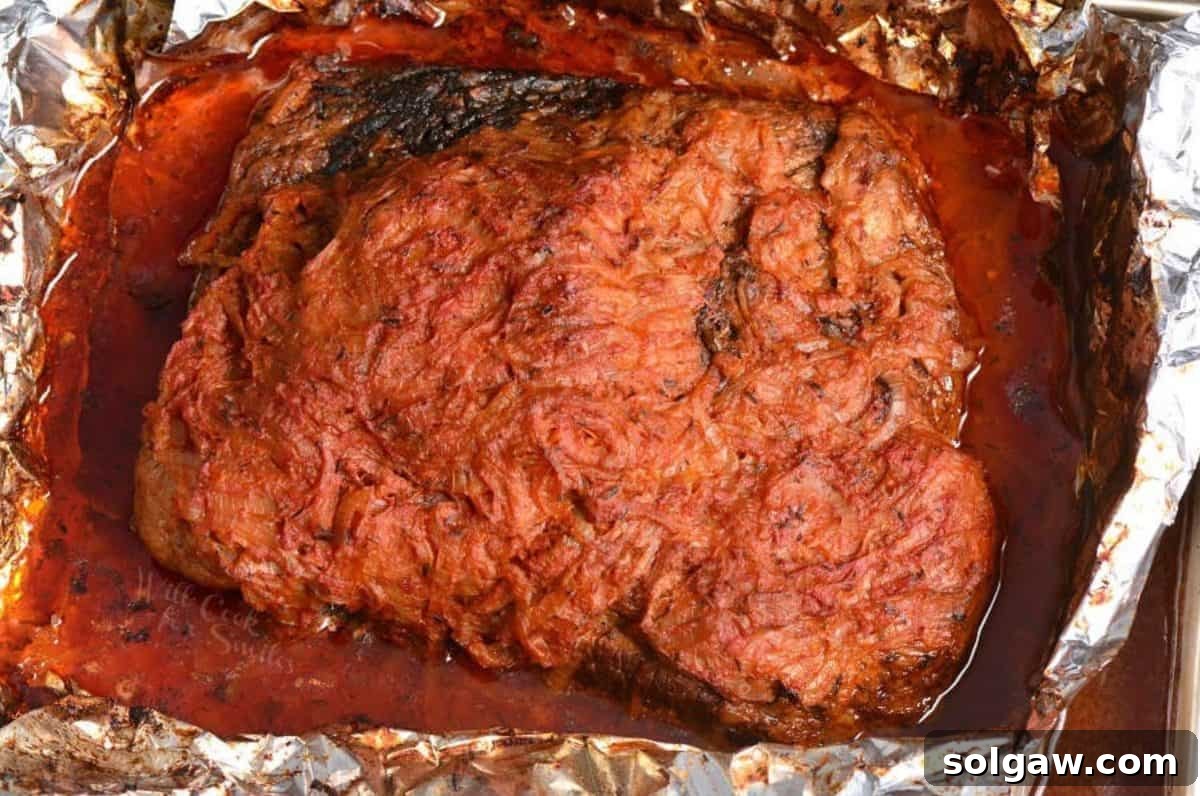 cooked French onion beef brisket in the roasting pan in foil.
