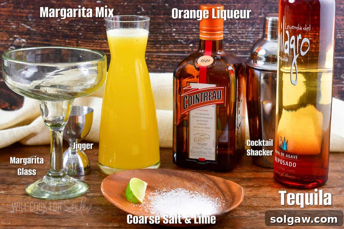 Essential ingredients for a classic margarita laid out on a rustic wooden board.