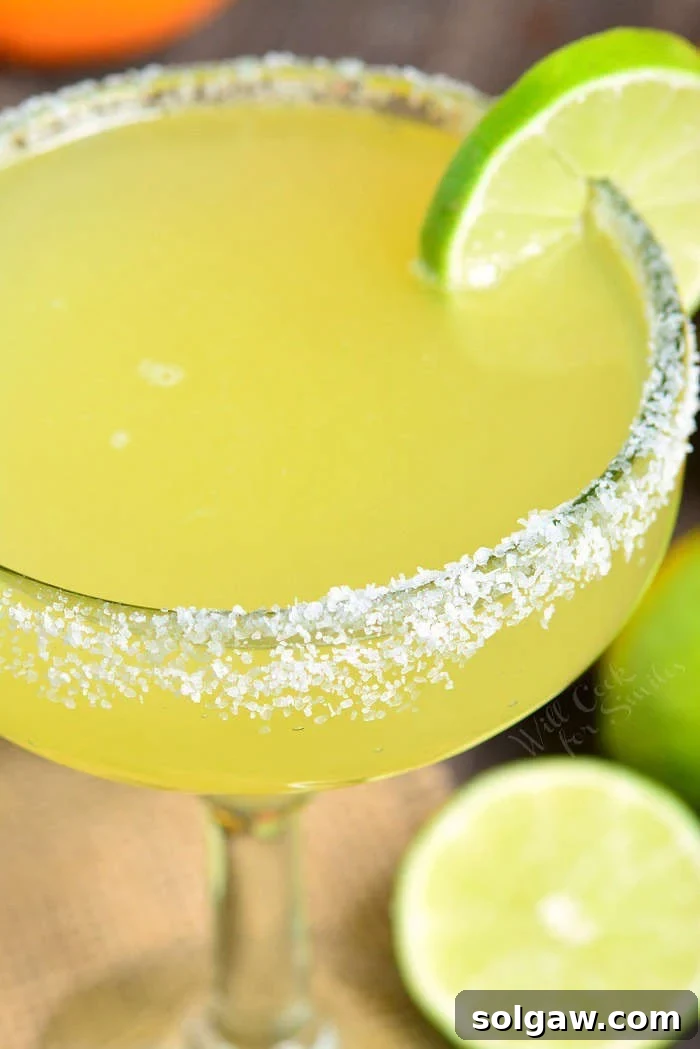 A large pitcher of homemade margarita, ready to serve multiple guests.