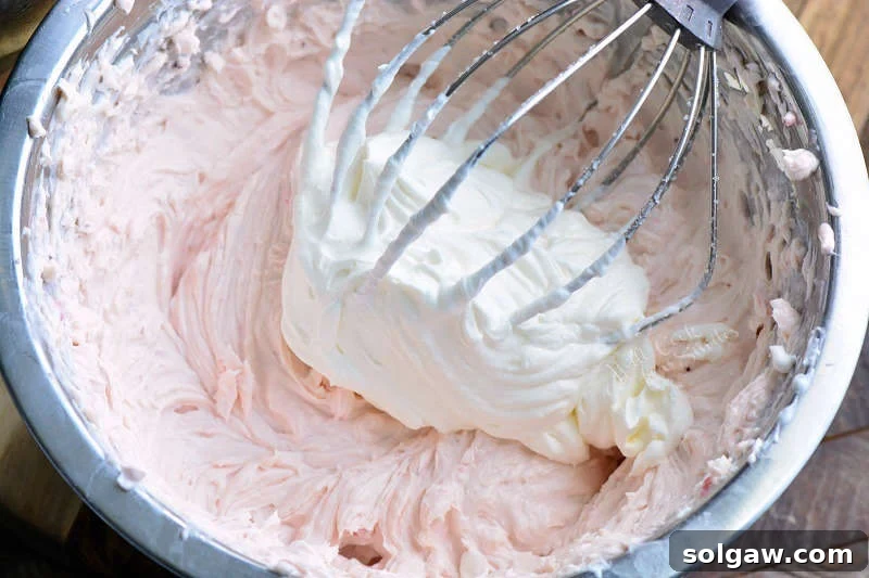 No-bake cheesecake filling mixture in a metal bowl, ready for whipped cream