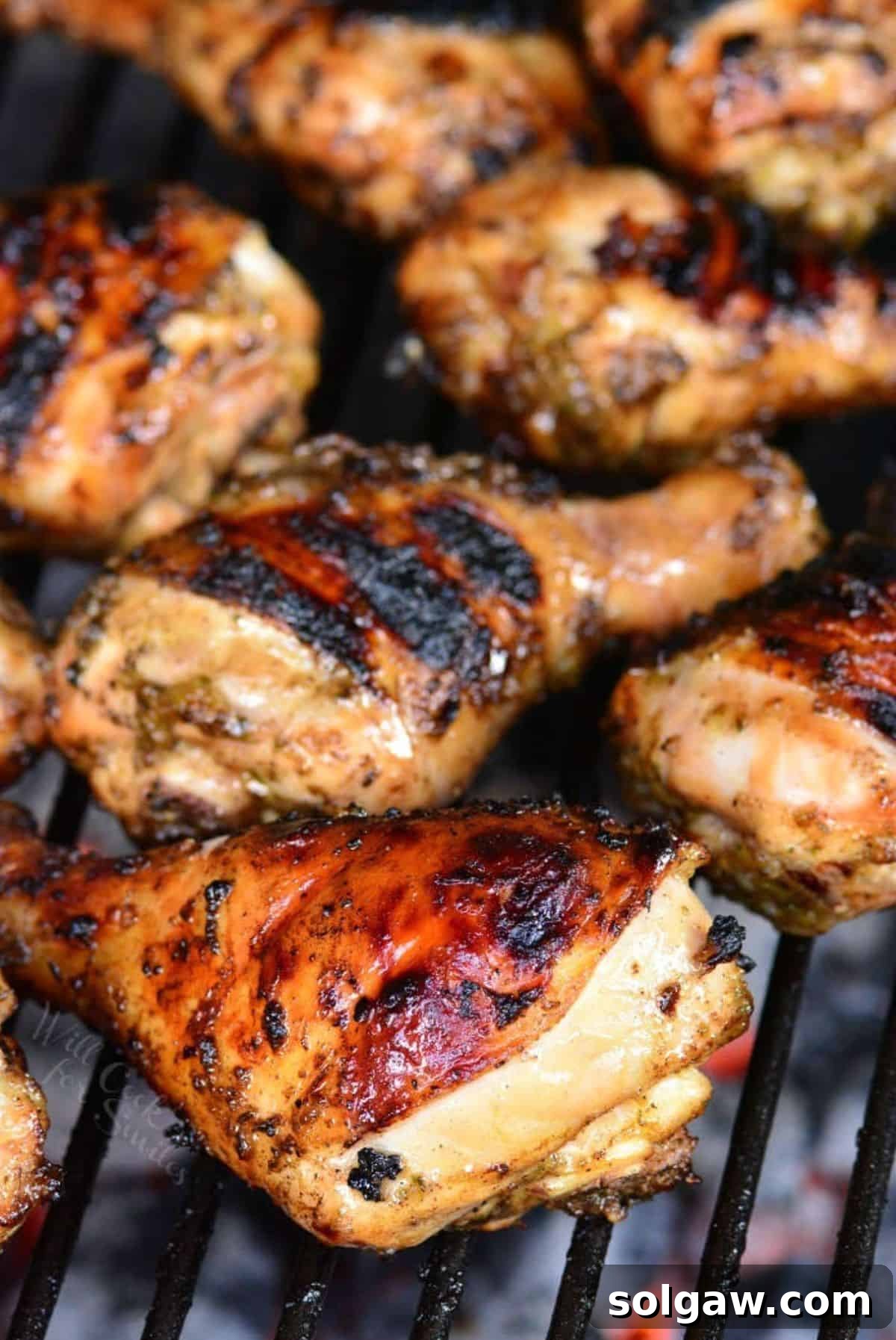 marinated chicken drumstick cooking on the grill.