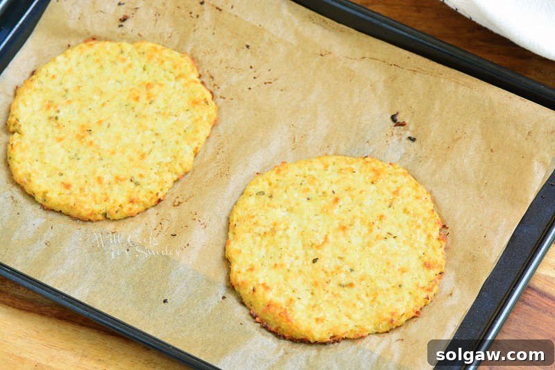 cooked cauliflower on parchment paper on a baking sheet 